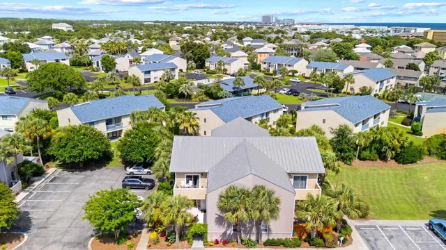 an aerial view of residential houses with outdoor space and trees