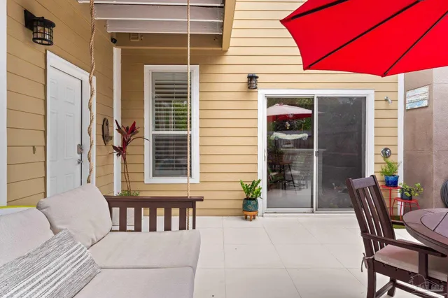 a view of a house with a porch and furniture