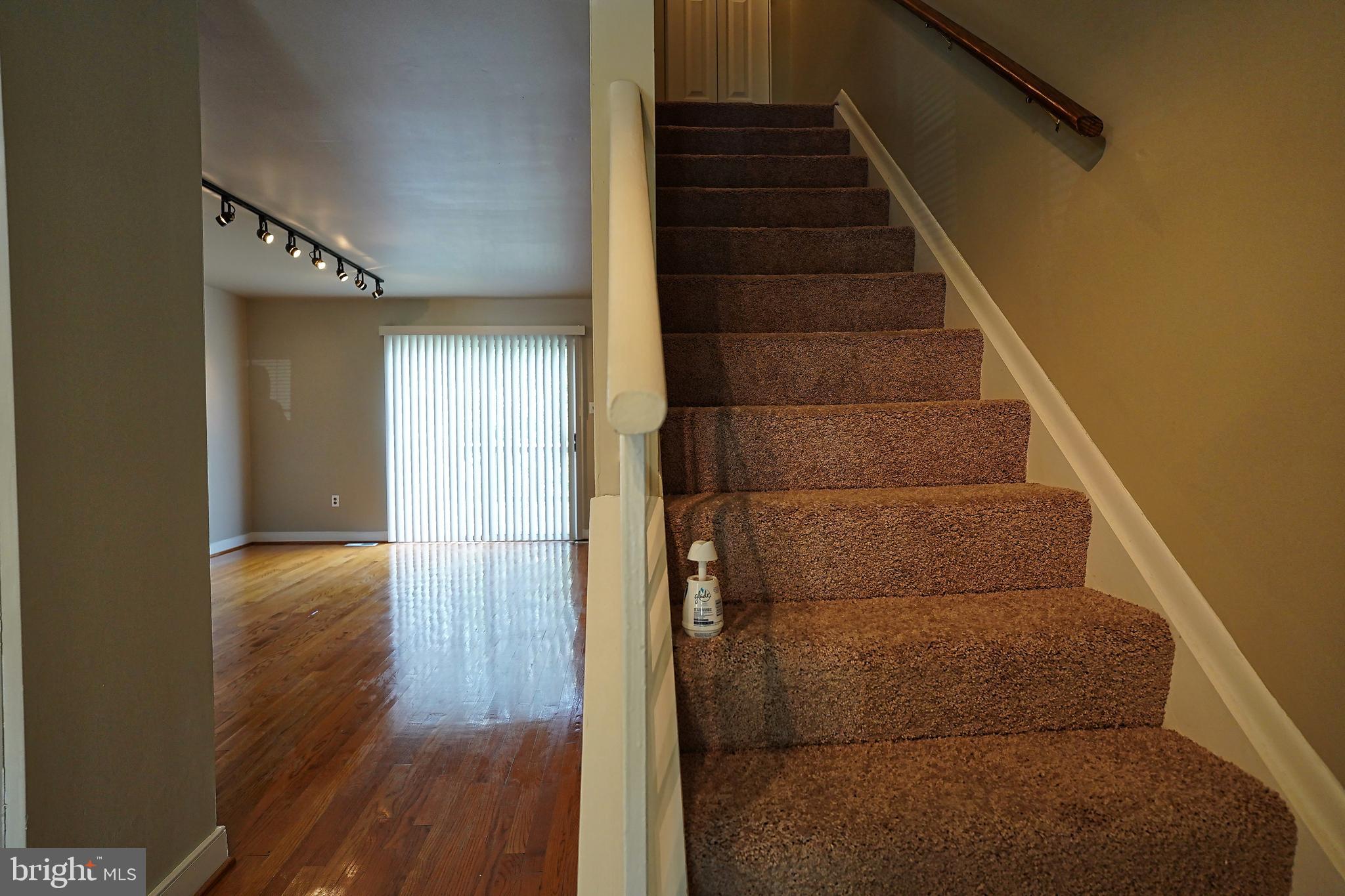 6948 Rockfield Road Baltimore, MD 21244 - Photo 25 of 47 a view of entryway with wooden floor and stairs