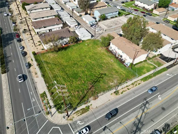 an aerial view of a residential houses with yard