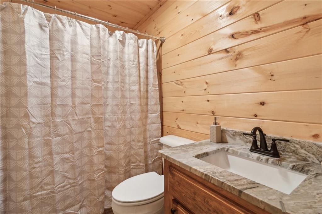519 Barnes Drive Ellijay, GA 30540 - Photo 11 of 15 a bathroom with a granite countertop sink toilet and shower