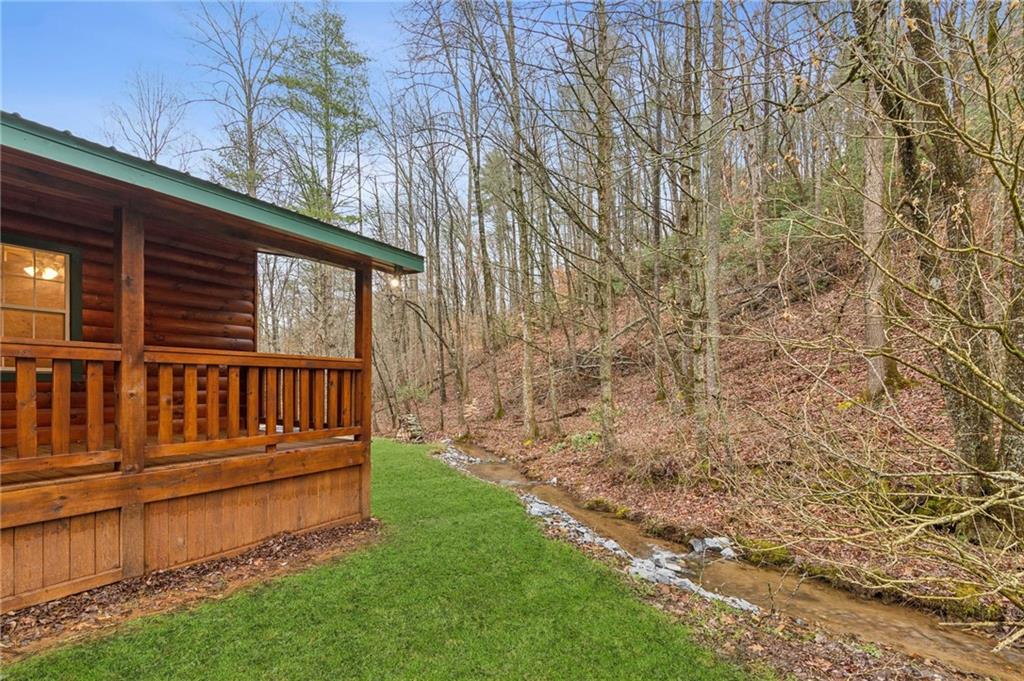 519 Barnes Drive Ellijay, GA 30540 - Photo 14 of 15 a view of a backyard with wooden fence and large trees