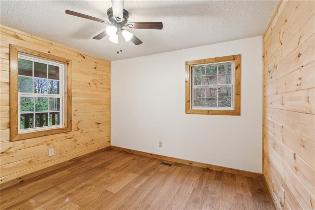 519 Barnes Drive Ellijay, GA 30540 - Photo 10 of 15 an empty room with a window and wooden floor