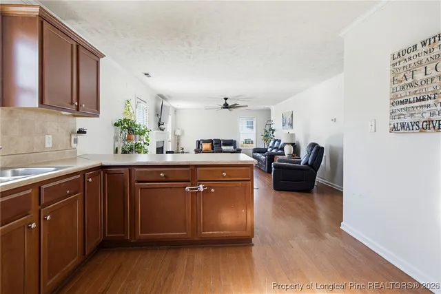 a kitchen with sink cabinets and wooden floor