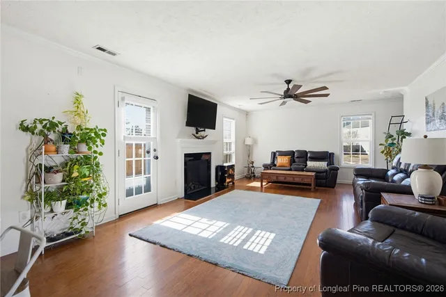 a living room with furniture a fireplace and a flat screen tv