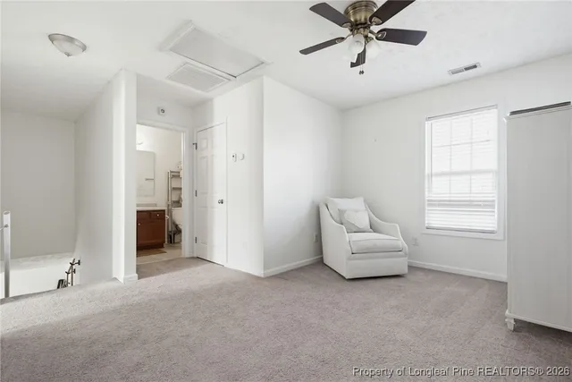 a living room with furniture and a ceiling fan