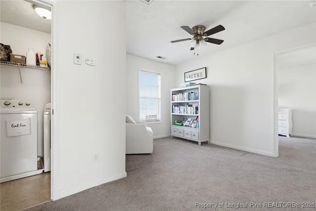 a view of workspace with furniture and a ceiling fan