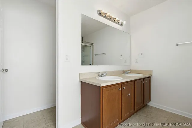 a utility room with a sink and a mirror