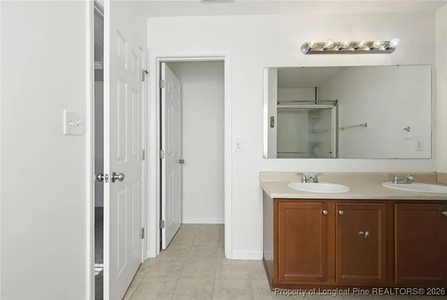 a bathroom with a double vanity sink mirror and