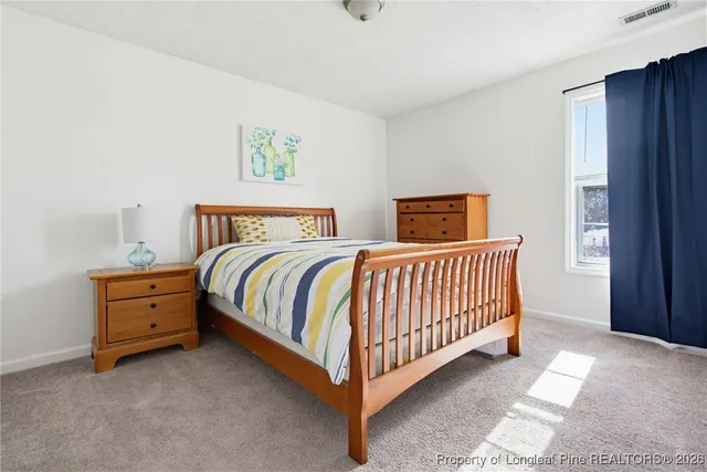 a bed room with a bed and a window