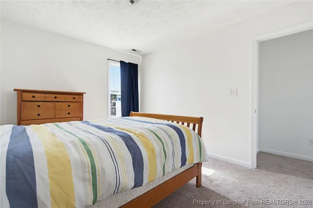 a bedroom with a bed and dresser