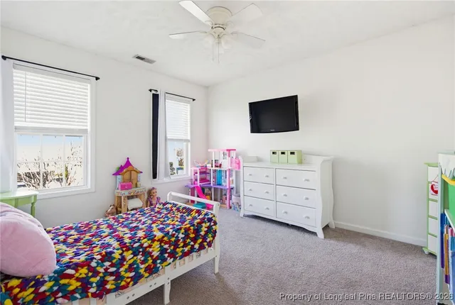 a bedroom with furniture and a flat screen tv