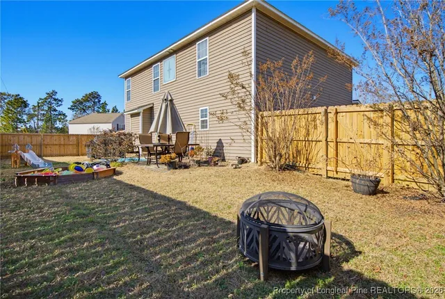 a swimming pool with outdoor seating and yard