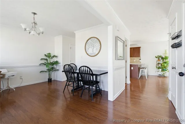 a view of a livingroom with furniture wooden floor a chandelier
