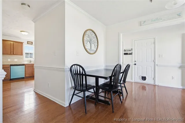 a view of a dining room with furniture and wooden floor