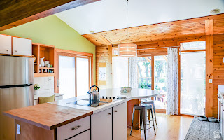 578 High Bench Road Alpine, UT 84004 - Photo 22 of 39 Kitchen featuring a central island with integrated cooktop, light wood cabinetry, stainless steel refrigerator, wood-finish flooring, and a vaulted ceiling with exposed wood beams
