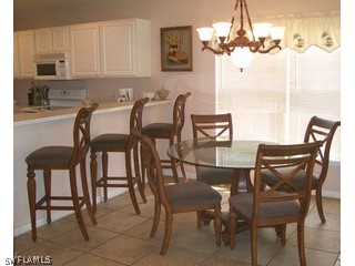 17732 Oakmont Ridge Circle Fort Myers, FL 33967 - Photo 3 of 7 a view of a dining room with furniture and chandelier
