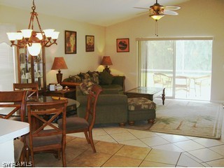 17732 Oakmont Ridge Circle Fort Myers, FL 33967 - Photo 4 of 7 a living room with fireplace furniture and a window