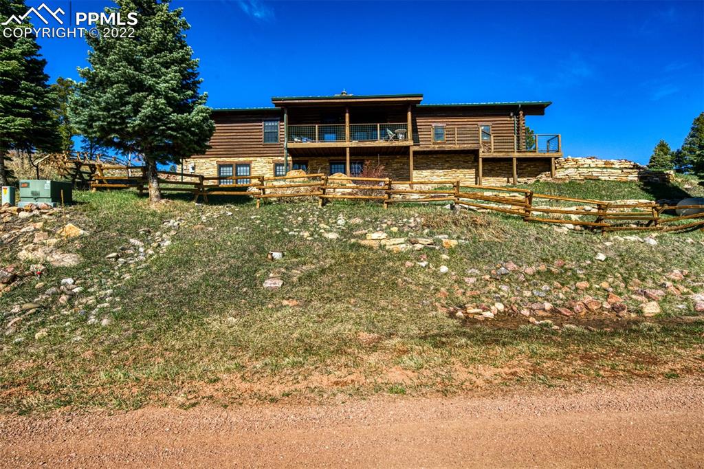 8774 Ridge Road Beulah, CO 81023 - Photo 1 of 46 a front view of a house with garden