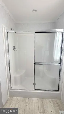 a bathroom with a glass shower door