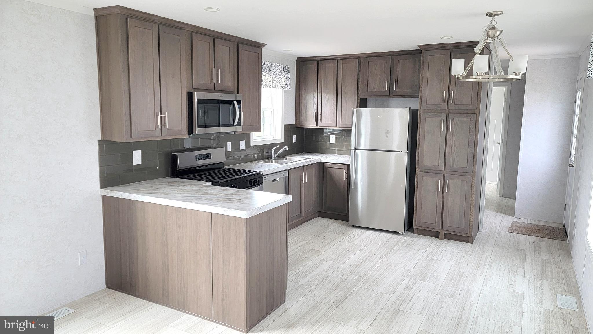 89 Valley View Road Birdsboro, PA 19508 - Photo 4 of 21 a kitchen with a refrigerator sink and cabinets