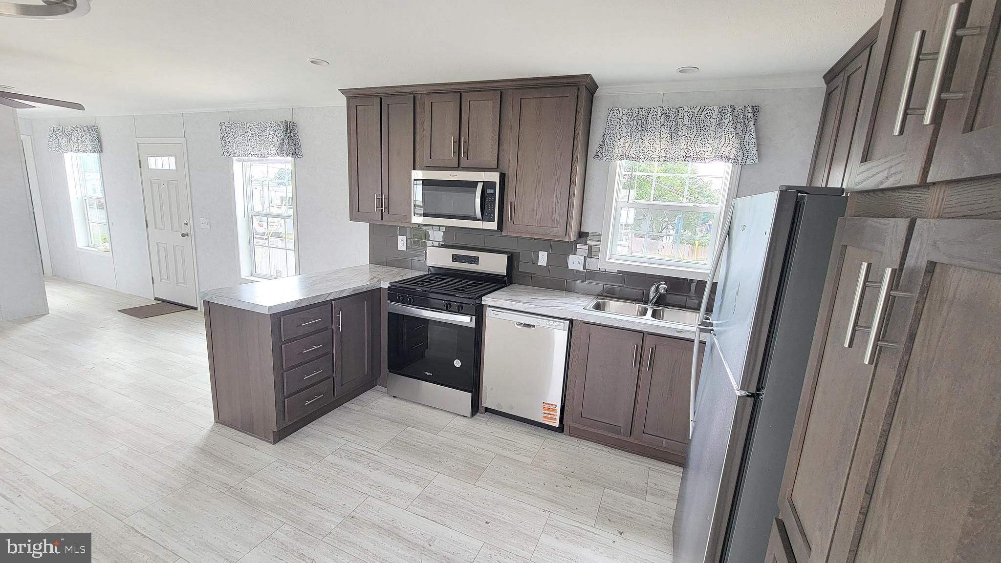 89 Valley View Road Birdsboro, PA 19508 - Photo 6 of 21 a kitchen with stainless steel appliances granite countertop a refrigerator a sink a stove a washer dryer and a refrigerator