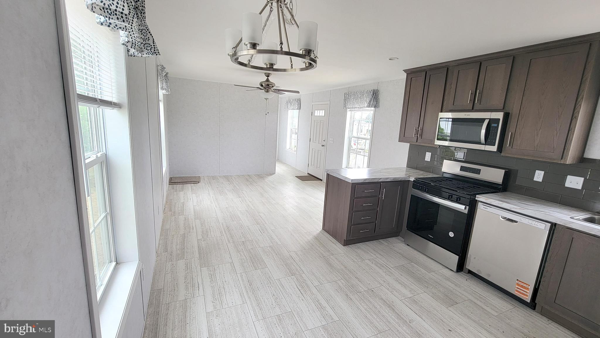 89 Valley View Road Birdsboro, PA 19508 - Photo 7 of 21 a kitchen with stainless steel appliances granite countertop a refrigerator a sink dishwasher a stove and white countertops with wooden floor