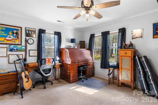 a bathroom with a sink a toilet a mirror and shower curtain