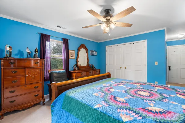 a view of a white house with a yard covered with snow in front of house