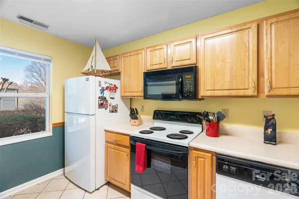 a kitchen with a refrigerator a stove a microwave and cabinets