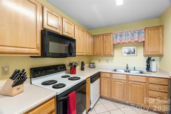 a kitchen with a sink a stove and cabinets