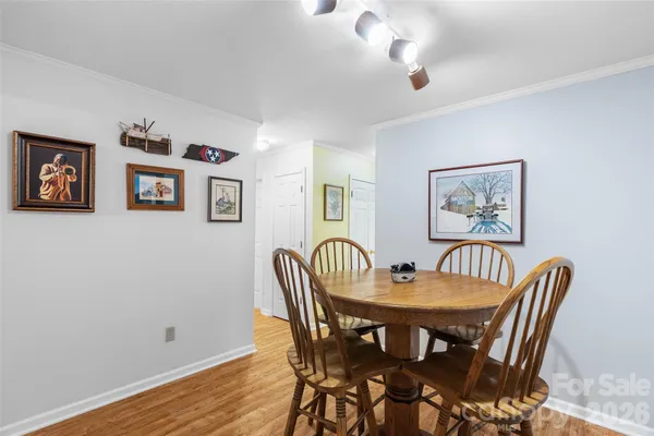 a dining room with furniture and wooden floor