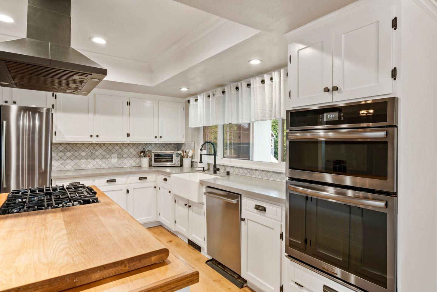 105 Rays Circle Hollister, CA 95023 - Photo 12 of 37 a kitchen with kitchen island a stove sink and cabinets