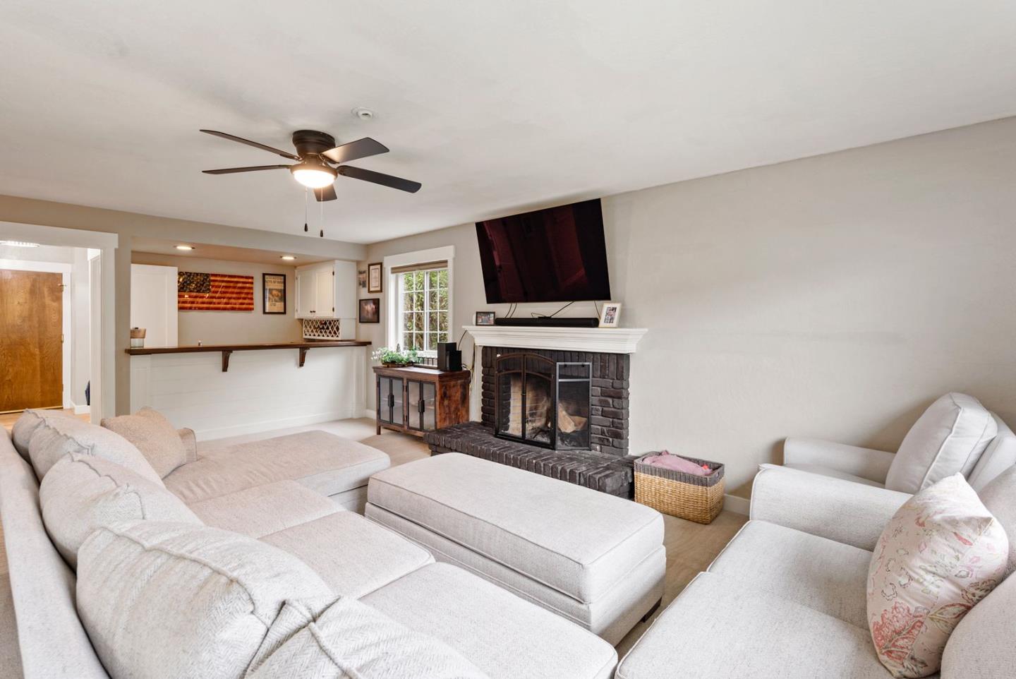 105 Rays Circle Hollister, CA 95023 - Photo 15 of 37 a living room with furniture a fireplace and a flat screen tv