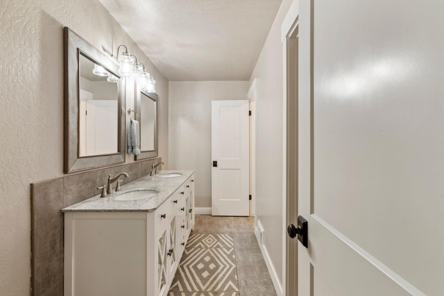 105 Rays Circle Hollister, CA 95023 - Photo 30 of 37 a spacious bathroom with a sink and a mirror