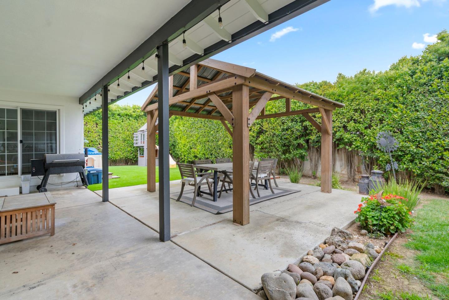 105 Rays Circle Hollister, CA 95023 - Photo 30 of 36 a view of a patio with table and chairs potted plants and large tree