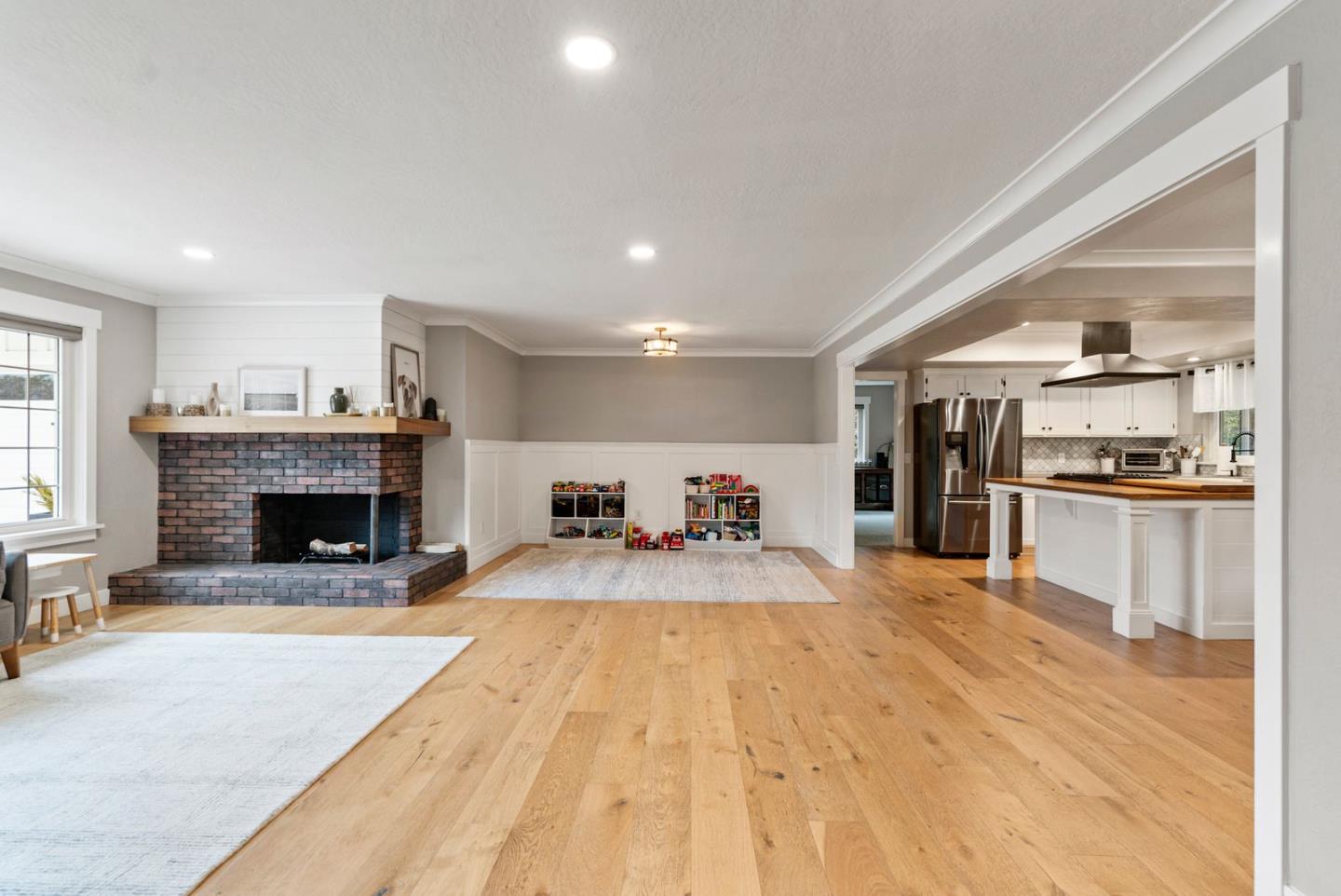 105 Rays Circle Hollister, CA 95023 - Photo 6 of 36 a large white kitchen with a sink stainless steel appliances and a fireplace