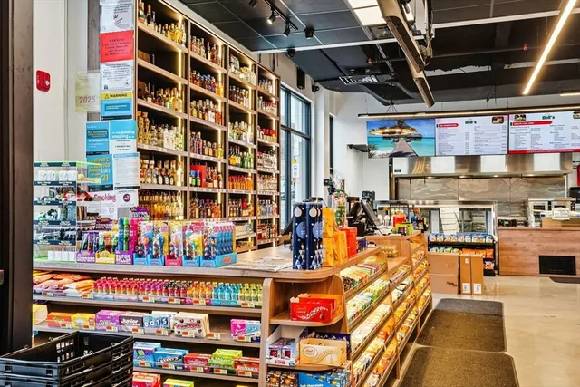 a utility room with lots of clutter and cabinets