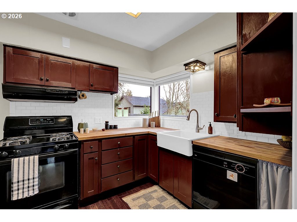 5537 Southwest Florida Street Portland, OR 97219 - Photo 15 of 45 a kitchen with granite countertop a sink cabinets and stainless steel appliances