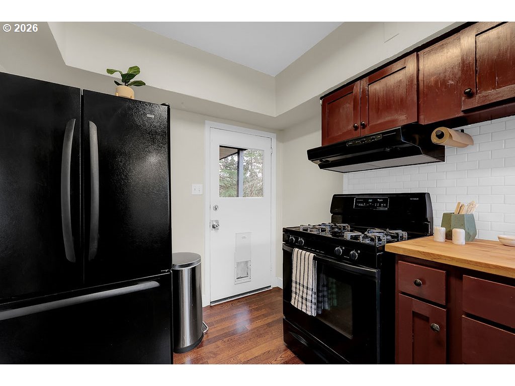 5537 Southwest Florida Street Portland, OR 97219 - Photo 16 of 45 a kitchen with stainless steel appliances a stove a refrigerator and a sink