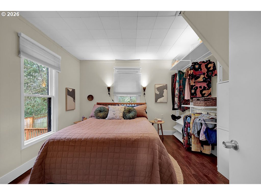 5537 Southwest Florida Street Portland, OR 97219 - Photo 21 of 45 a bedroom with a bed and a wooden floor
