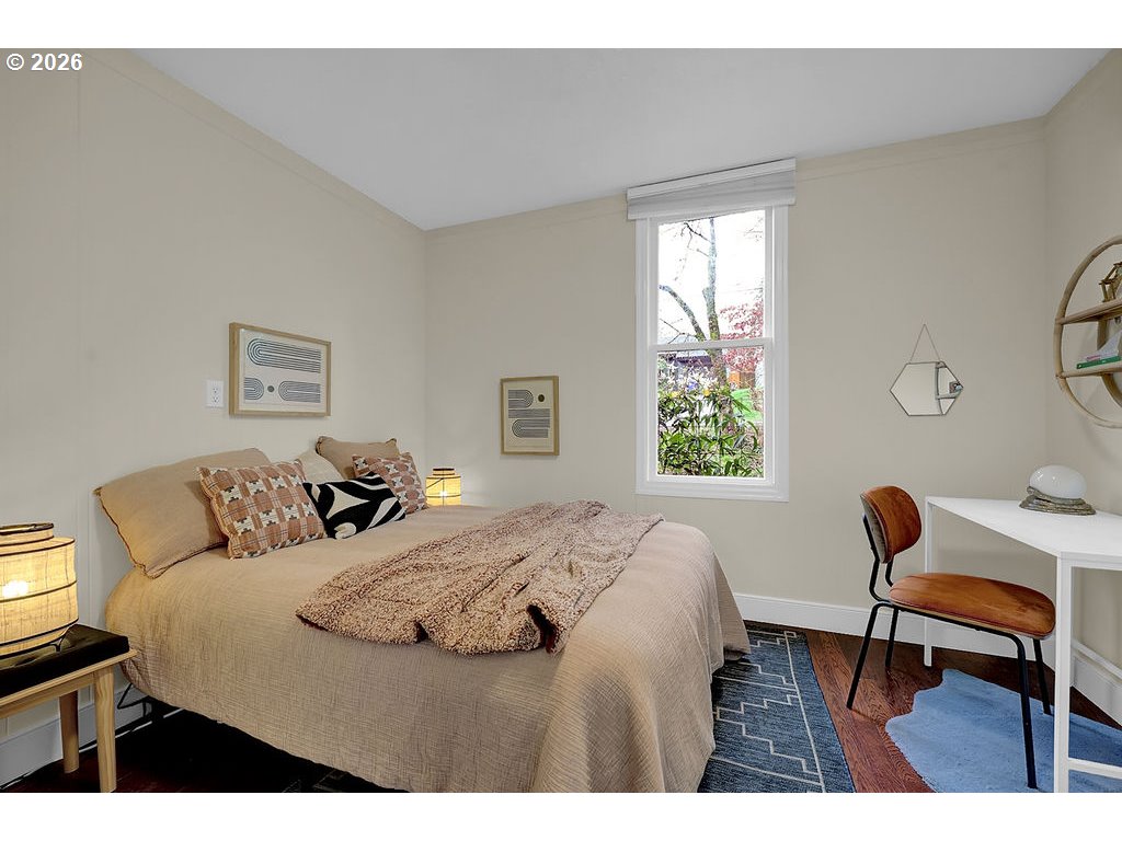 5537 Southwest Florida Street Portland, OR 97219 - Photo 24 of 45 a bedroom with a bed a table and chair
