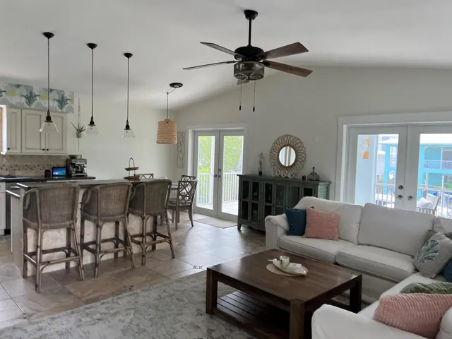 a living room with furniture a rug and a chandelier