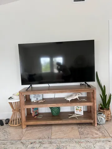 a room with a flat screen tv and outdoor seating