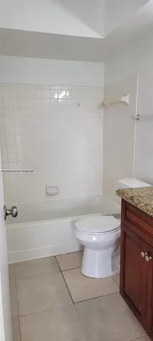 a bathroom with a toilet a sink and shower