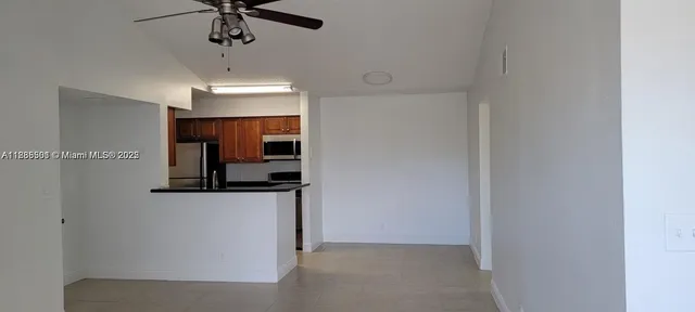 a view of a hallway with a kitchen