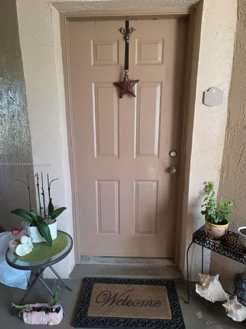 a view of a hallway with furniture and front door