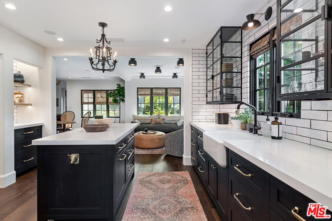 4416 Arcola Avenue Toluca Lake, CA 91602 - Photo 23 of 46 a kitchen with a counter space a sink appliances and cabinets