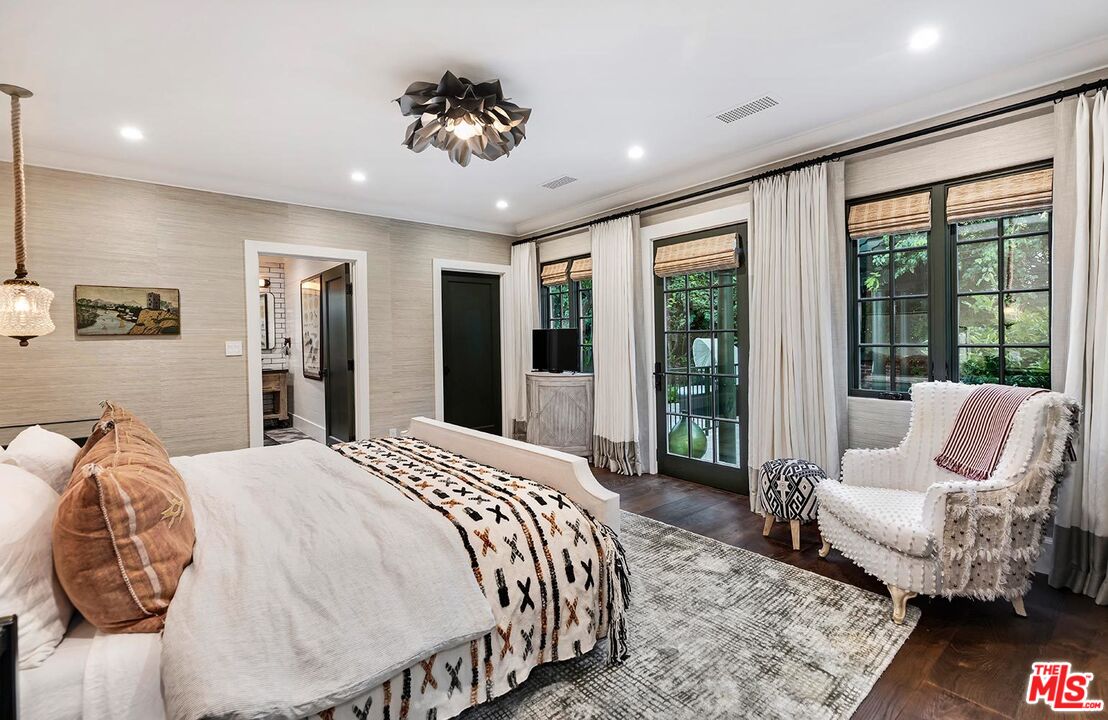 4416 Arcola Avenue Toluca Lake, CA 91602 - Photo 25 of 46 a spacious bedroom with a large bed and a couch