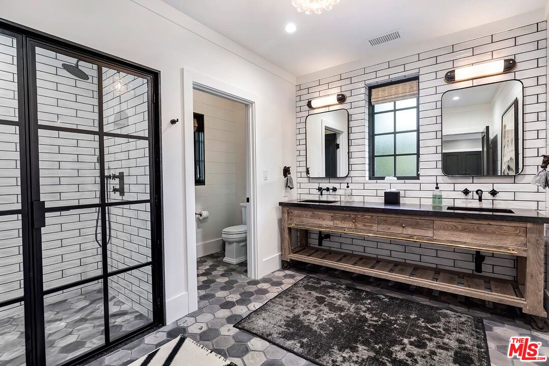 4416 Arcola Avenue Toluca Lake, CA 91602 - Photo 26 of 46 a bathroom with a double vanity sink and a mirror